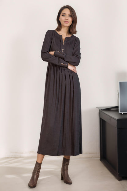 May include: A long-sleeved, dark gray dress with a button-up front and a gathered skirt.