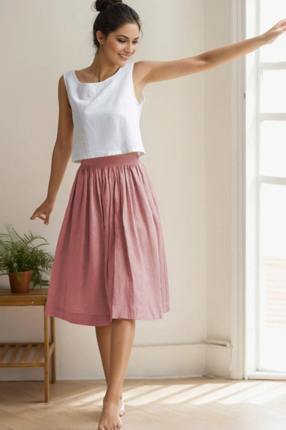 May include: A pink linen midi skirt with a gathered waistband.